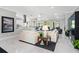 Bright and airy living room featuring marble flooring, neutral decor, and seamless flow into the kitchen area at 6106 Spinnaker Loop, Lady Lake, FL 32159