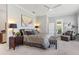 Spacious main bedroom features a ceiling fan, dresser, and art at 6106 Spinnaker Loop, Lady Lake, FL 32159