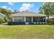 Well-maintained home with a spacious backyard, manicured lawn, and screened-in patio, perfect for outdoor living at 6106 Spinnaker Loop, Lady Lake, FL 32159