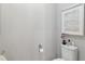 Neutral half bathroom showcasing a toilet and small vanity with decorative accents at 6106 Spinnaker Loop, Lady Lake, FL 32159