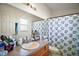 Clean bathroom featuring turtle-themed shower curtain, ample counter space, and a large, bright mirror at 638 Sierra Cir, Davenport, FL 33837