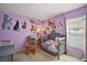 Cheerful room with vibrant purple walls adorned with classic Disney cartoon character decals at 638 Sierra Cir, Davenport, FL 33837