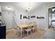Bright dining room with a classic chandelier and elegant china cabinet at 638 Sierra Cir, Davenport, FL 33837