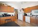Traditional-style kitchen with wood cabinets, tiled floor, and white appliances offers ample storage and functionality at 638 Sierra Cir, Davenport, FL 33837