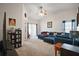 Cozy living room featuring a vaulted ceiling and plush blue sectional sofa at 638 Sierra Cir, Davenport, FL 33837