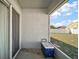 A covered patio with a cooler overlooks the fenced backyard and offers outdoor living space at 638 Sierra Cir, Davenport, FL 33837