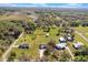 Aerial view of land with a outlined home, metal building and trees on a sunny day with scattered clouds at 6679 Cr 613, Bushnell, FL 33513