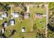 Aerial view of residential neighborhood with tree-lined streets, green yards and several houses with individual driveways at 6679 Cr 613, Bushnell, FL 33513