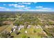 Aerial view of multiple residential properties surrounded by lush greenery on a sunny day with scattered clouds at 6679 Cr 613, Bushnell, FL 33513