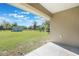 View of the backyard from the patio showcasing an expansive green lawn and barn at 6679 Cr 613, Bushnell, FL 33513