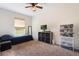 This cozy bedroom features a large window, a ceiling fan and ample storage at 6679 Cr 613, Bushnell, FL 33513