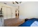 Cozy carpeted bedroom featuring a ceiling fan and an entrance to the kitchen area at 6679 Cr 613, Bushnell, FL 33513