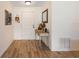 Inviting entryway with wood-look tile flooring, a stylish console table, and a charming display of flowers and decor at 6679 Cr 613, Bushnell, FL 33513