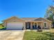 Charming single-story home featuring an attached two-car garage and a well-manicured front lawn at 6679 Cr 613, Bushnell, FL 33513