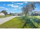 Well-kept property featuring a large yard, mature trees, and a welcoming home with a long driveway, ideal for families at 6679 Cr 613, Bushnell, FL 33513