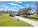 Spacious property with a well-maintained lawn, mature trees, and a long driveway leading to a charming single-Gathering home at 6679 Cr 613, Bushnell, FL 33513