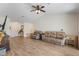 Bright living room featuring wood-look tile flooring, vaulted ceilings, and comfortable seating, perfect for relaxation at 6679 Cr 613, Bushnell, FL 33513