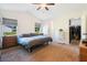This spacious main bedroom offers a ceiling fan and convenient access to a walk-in closet at 6679 Cr 613, Bushnell, FL 33513
