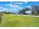 Lush green property showcasing an expansive lawn, mature trees, and a charming home with a long driveway at 6679 Cr 613, Bushnell, FL 33513