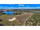 A panoramic aerial perspective of property showcasing lake, groves, and structures at 6988 Blue Cedar Rd, Leesburg, FL 34748
