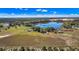 Stunning aerial view of a large estate featuring a private lake and outbuildings on a vast property at 6988 Blue Cedar Rd, Leesburg, FL 34748