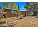 Charming brick home with a metal roof and well-maintained front yard landscaping at 6988 Blue Cedar Rd, Leesburg, FL 34748