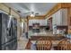 This kitchen has brick backsplash, stainless appliances, and breakfast bar seating at 6988 Blue Cedar Rd, Leesburg, FL 34748