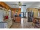 Spacious kitchen boasts tile floors, wood walls, and stainless steel refrigerator at 6988 Blue Cedar Rd, Leesburg, FL 34748