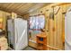 Pantry with wood walls provides additional storage space in the kitchen at 6988 Blue Cedar Rd, Leesburg, FL 34748
