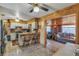 Cozy kitchen features wood paneling, breakfast bar with seating, and white cabinets at 6988 Blue Cedar Rd, Leesburg, FL 34748