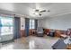 Comfortable living room with tile floors, wood paneling, and a recliner by a view of the lake at 6988 Blue Cedar Rd, Leesburg, FL 34748