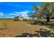 Exterior view of a storage shed in a spacious yard on a sunny day at 6988 Blue Cedar Rd, Leesburg, FL 34748