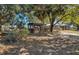 Shaded yard featuring a charming outdoor area with nearby main house and patio at 6988 Blue Cedar Rd, Leesburg, FL 34748