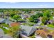 Overhead view showcases a quiet neighborhood street lined with houses and mature trees at 733 Palma Dr, The Villages, FL 32159