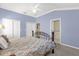 Bright bedroom features a wrought iron bed, carpeting, and access to a walk-in shower and double closets at 733 Palma Dr, The Villages, FL 32159