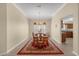 Formal dining room features wood table with seating for six and decorative chandelier at 733 Palma Dr, The Villages, FL 32159