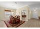 Open dining room offers wood table with seating for six and view of entryway at 733 Palma Dr, The Villages, FL 32159