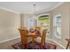 Dining nook featuring round table, seating for four, and view of landscaped yard at 733 Palma Dr, The Villages, FL 32159