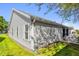 Shows the side and backyard of a house with vinyl siding and well-maintained landscaping at 733 Palma Dr, The Villages, FL 32159