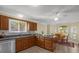 Kitchen features wooden cabinets, granite countertops, and stainless steel appliances at 733 Palma Dr, The Villages, FL 32159