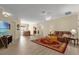 Open living room with a large area rug, neutral walls, and a view into the dining room and kitchen at 733 Palma Dr, The Villages, FL 32159