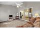 Sunroom with fan and furniture looking out onto the open-concept living space through sliding glass doors at 733 Palma Dr, The Villages, FL 32159