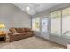Bright sunroom with a couch, carpet, and multiple windows, with access to an outdoor space at 733 Palma Dr, The Villages, FL 32159