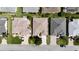 An aerial view features the roof of a home with neutral tones, driveway, and landscaping at 737 Caldwell Ct, The Villages, FL 32162