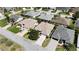 Aerial view of neutral colored homes in a well manicured neighborhood with palm trees at 737 Caldwell Ct, The Villages, FL 32162