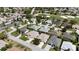 An aerial view displays neighborhood homes adjacent to a community golf course at 737 Caldwell Ct, The Villages, FL 32162
