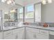 Bathroom features granite countertops, dual sinks, and stylish lighting for a luxurious feel at 737 Caldwell Ct, The Villages, FL 32162