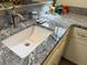 Granite countertop with white sink and decorative candles create a spa-like ambiance in this bathroom at 737 Caldwell Ct, The Villages, FL 32162