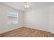 A cozy bedroom with a ceiling fan, window, and wood floors at 737 Caldwell Ct, The Villages, FL 32162
