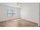 Bright bedroom with hardwood floors and a window providing natural light. Simple and serene space at 737 Caldwell Ct, The Villages, FL 32162